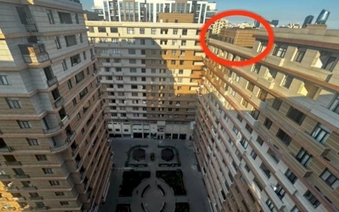 Bakıda ŞOK! 15 mərtəbəli binanın damında mənzil tikib, satışa çıxardılar - VİDEO